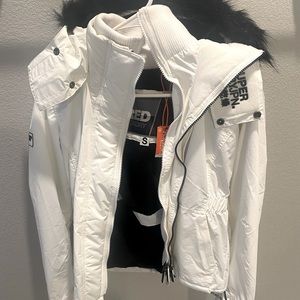 Super Dry, white bomber jacket, with black writing and fur hood.